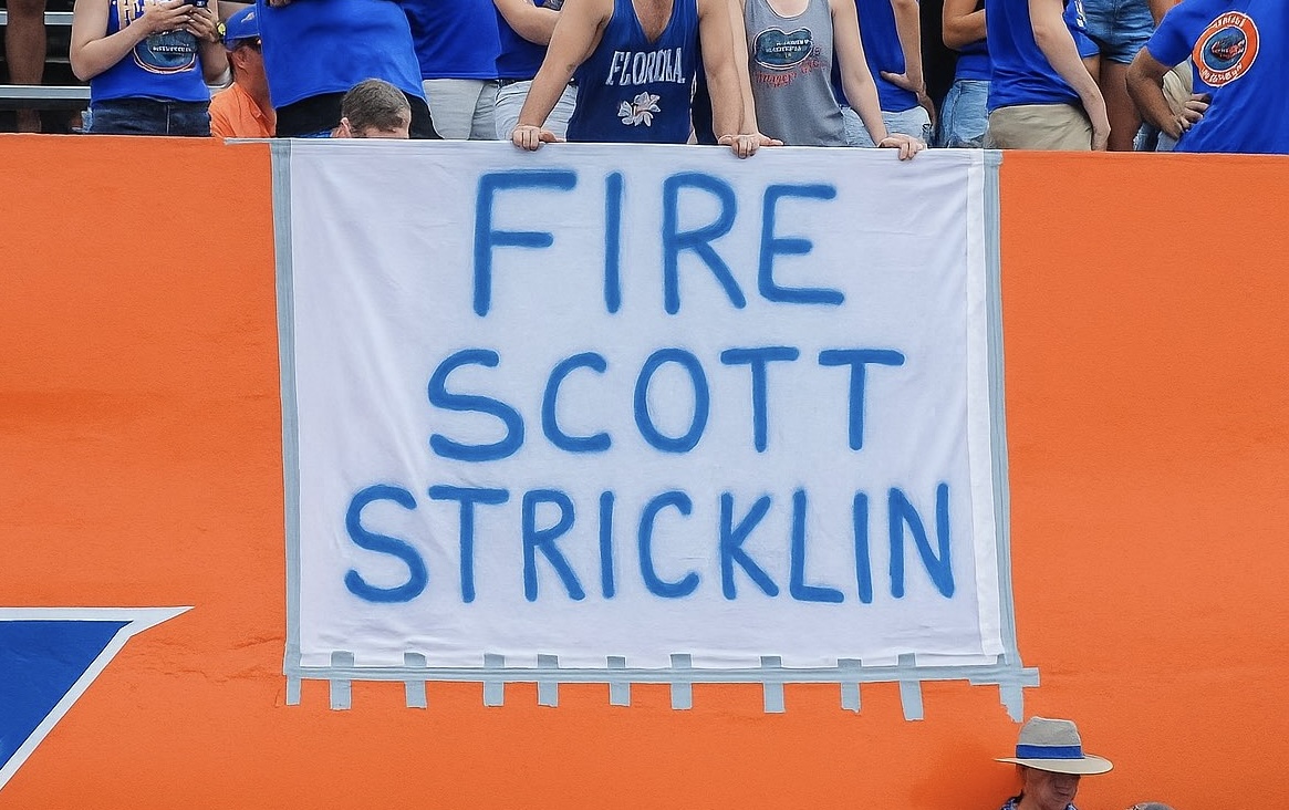 Florida Gators fans holding 'Fire Scott Stricklin' sign at game